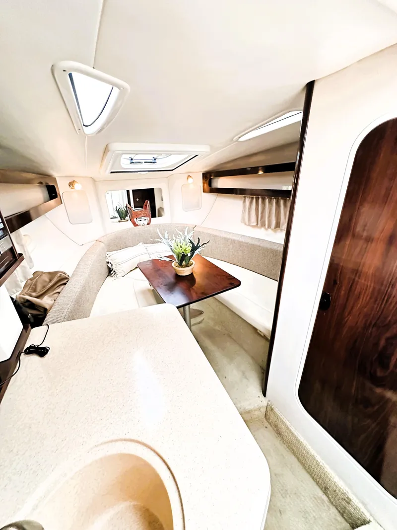 Slide: The Image of Interior of 2015 Sea Ray 260 Sundancer with cozy seating and table. - 9