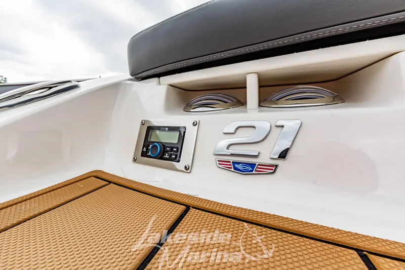 Slide: The Image of 2025 Chaparral 21 SSi boat interior detail with control panel and logo. - 10