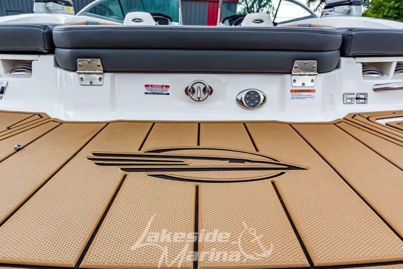 Slide: The Image of 2025 Chaparral 21 SSi boat deck with logo and cushioned seating. - 11