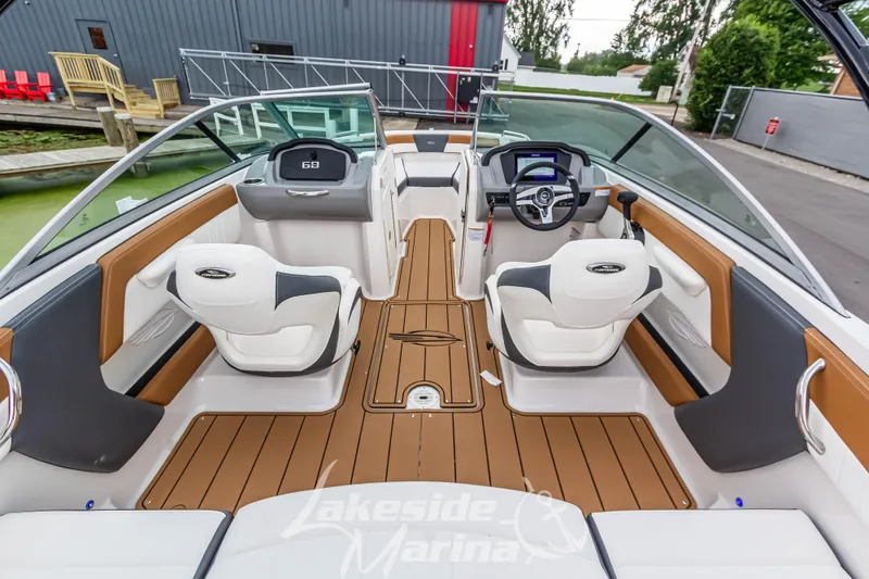 Slide: The Image of 2025 Chaparral 21 SSi boat interior with modern seating and dashboard at Lakeside Marina. - 14