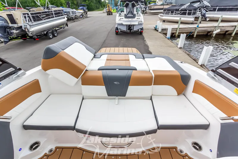 Slide: The Image of 2025 Chaparral 21 SSi boat with stylish seating at a marina dock. - 19