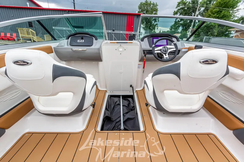 Slide: The Image of 2025 Chaparral 21 SSi boat interior with white seats and modern dashboard at Lakeside Marina. - 22