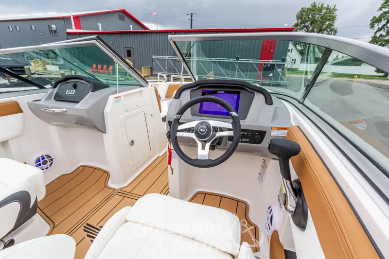 Slide: The Image of 2025 Chaparral 21 SSi boat interior with modern dashboard and steering wheel. - 24
