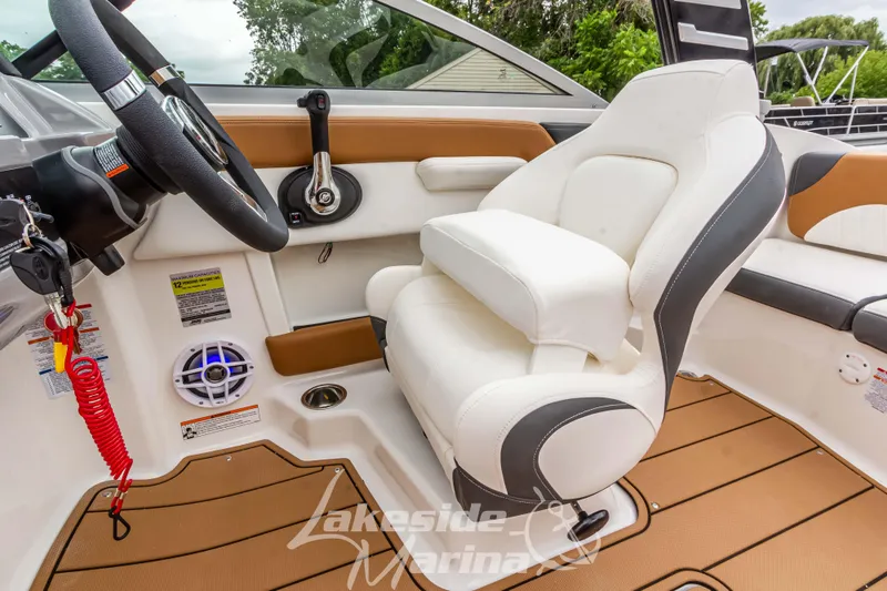 Slide: The Image of 2025 Chaparral 21 SSi boat interior with white seating and modern dashboard. - 27