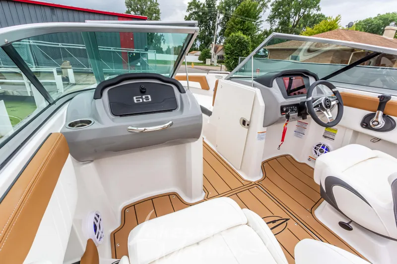 Slide: The Image of 2025 Chaparral 21 SSi boat interior with modern dashboard and seating. - 28