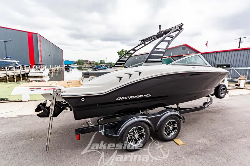 Slide: The Image of 2025 Chaparral 21 SSi boat on trailer at marina, overcast day. - 3