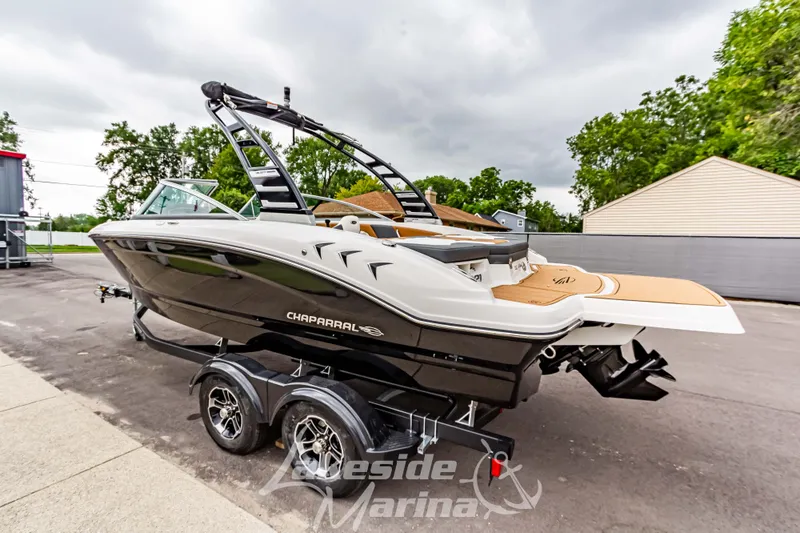 Slide: The Image of 2025 Chaparral 21 SSi boat on trailer, sleek design, parked outdoors. - 7