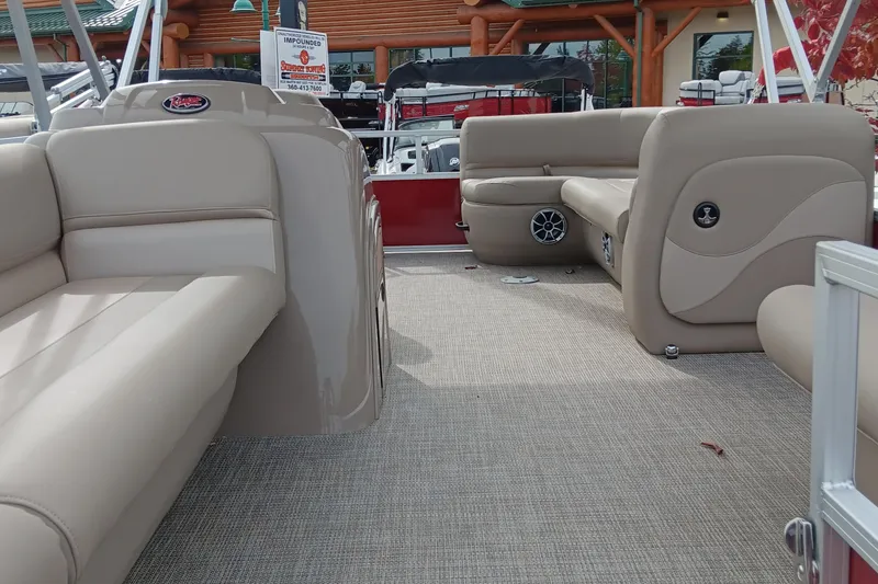Slide: The Image of 2024 Ranger Reata 200C boat interior with beige seating and carpeted floor. - 2