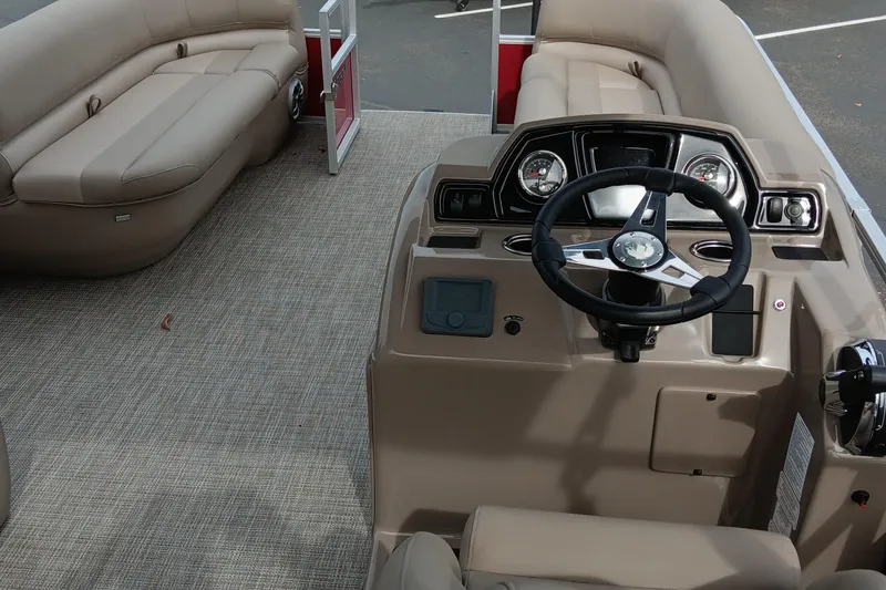 Slide: The Image of 2024 Ranger Reata 200C boat interior with beige seating and modern dashboard. - 3