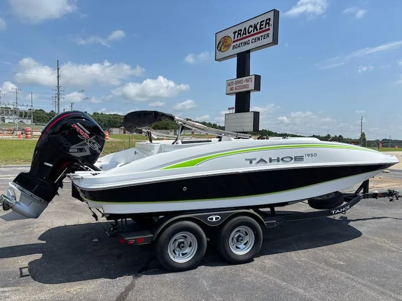 The Image of 2024 Tahoe 1950 boat on trailer at Tracker Boating Center, under clear blue sky. - 0
