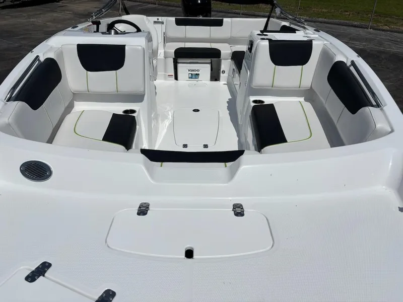 Slide: The Image of 2024 Tahoe 1950 boat interior with white and black seating, spacious layout. - 2