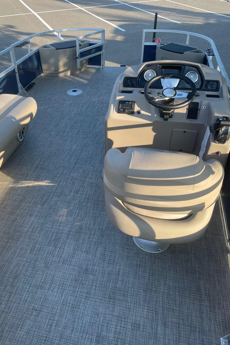 Slide: The Image of 2024 Ranger Reata 200F boat interior with steering console and seating. - 3