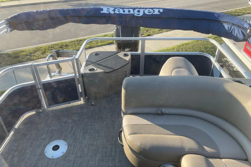 Slide: The Image of 2024 Ranger Reata 200F boat interior with seating and railing. - 5