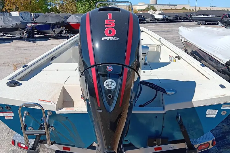 Slide: The Image of 2024 Ranger RB200 boat with 150 Pro outboard motor in a marina. - 2