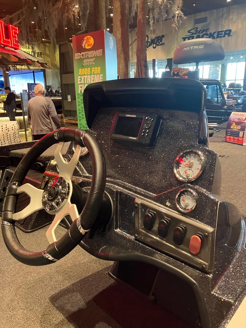 Slide: The Image of 2024 Nitro Z18 boat dashboard with steering wheel and control panel in showroom. - 4