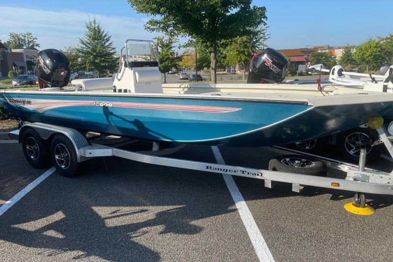 The Image of 2024 Ranger RB200 boat on trailer in parking lot, sunny day. - 0