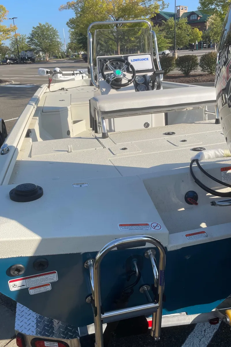 Slide: The Image of 2024 Ranger RB200 boat, spacious deck, modern controls, parked outdoors. - 3