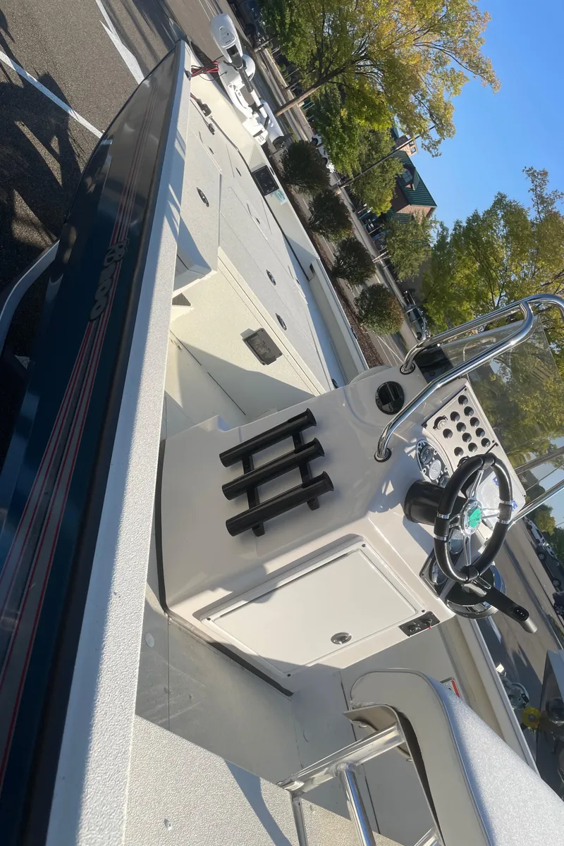 Slide: The Image of 2024 Ranger RB200 boat interior with steering console and rod holders. - 4