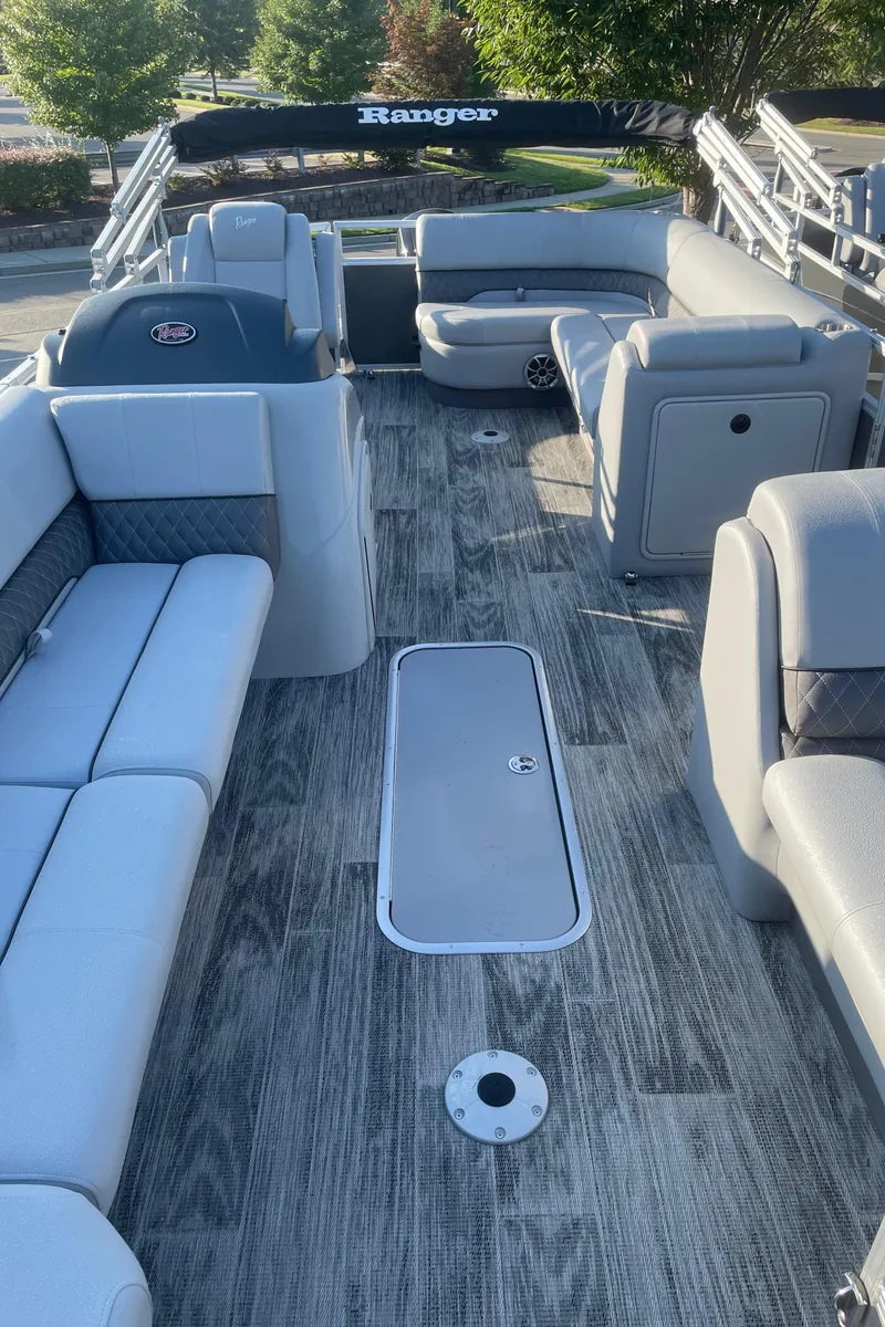 Slide: The Image of 2024 Ranger Reata 223C pontoon boat with spacious seating and modern design. - 3