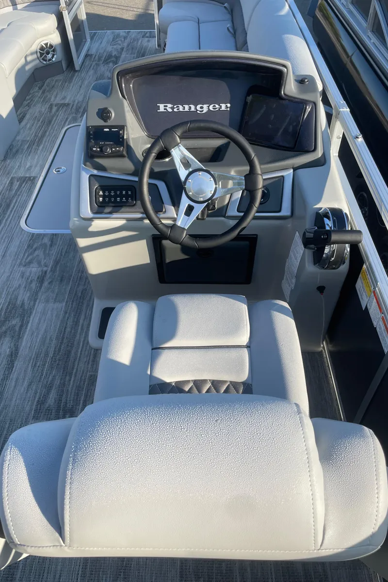 Slide: The Image of 2024 Ranger Reata 223C boat cockpit with steering wheel and control panel. - 5