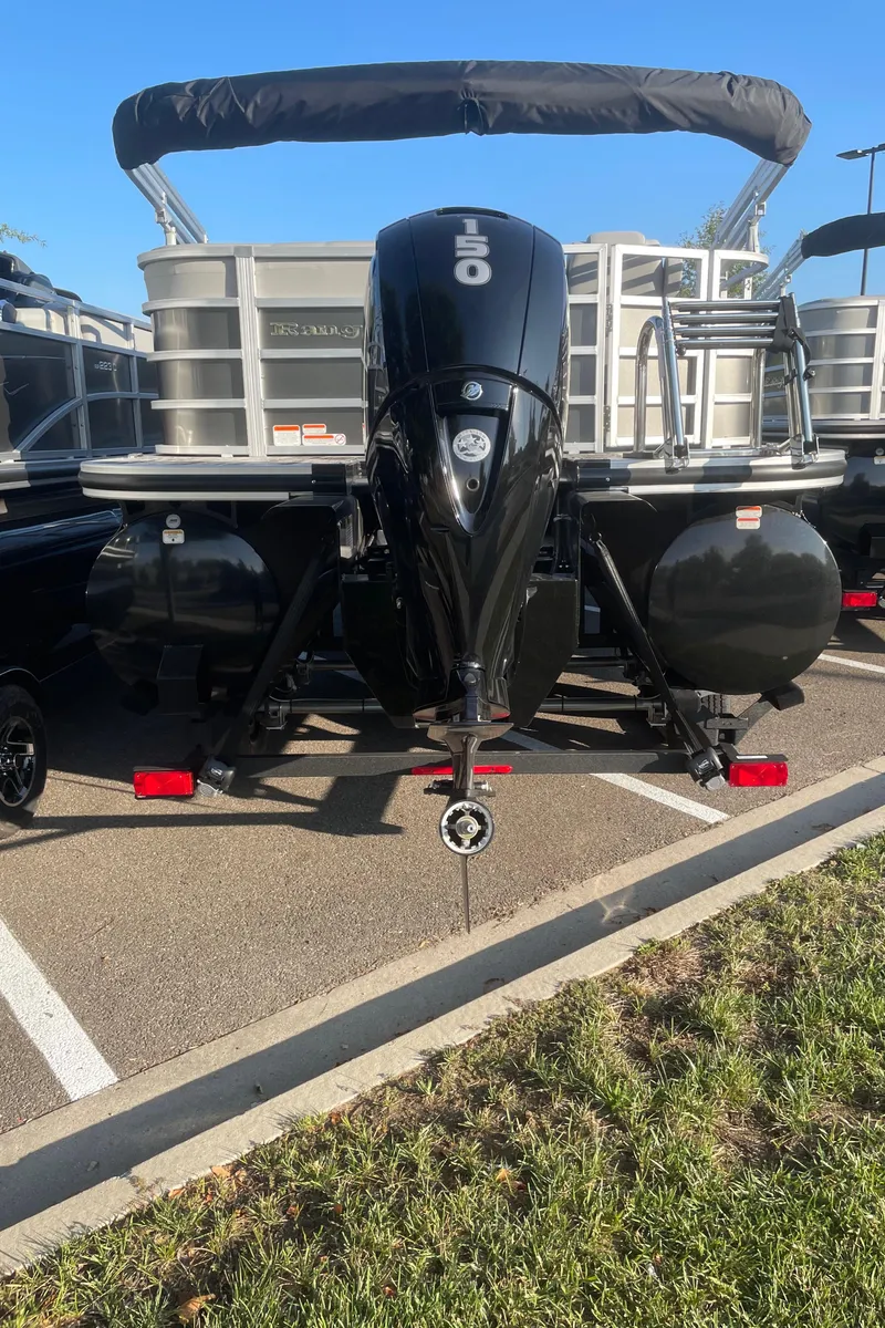Slide: The Image of 2024 Ranger Reata 223C pontoon boat with powerful outboard motor in parking lot. - 6