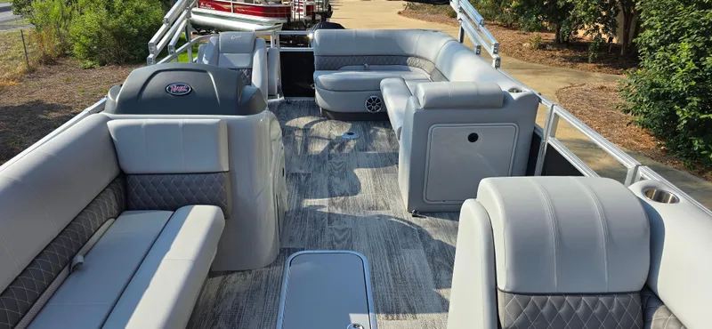 Slide: The Image of 2024 Ranger Reata 223C pontoon boat interior with gray seating and spacious layout. - 4