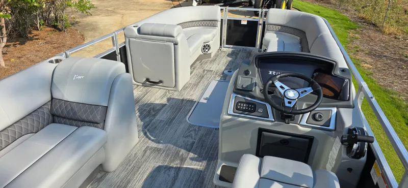 Slide: The Image of 2024 Ranger Reata 223C pontoon boat interior with modern seating and steering console. - 5