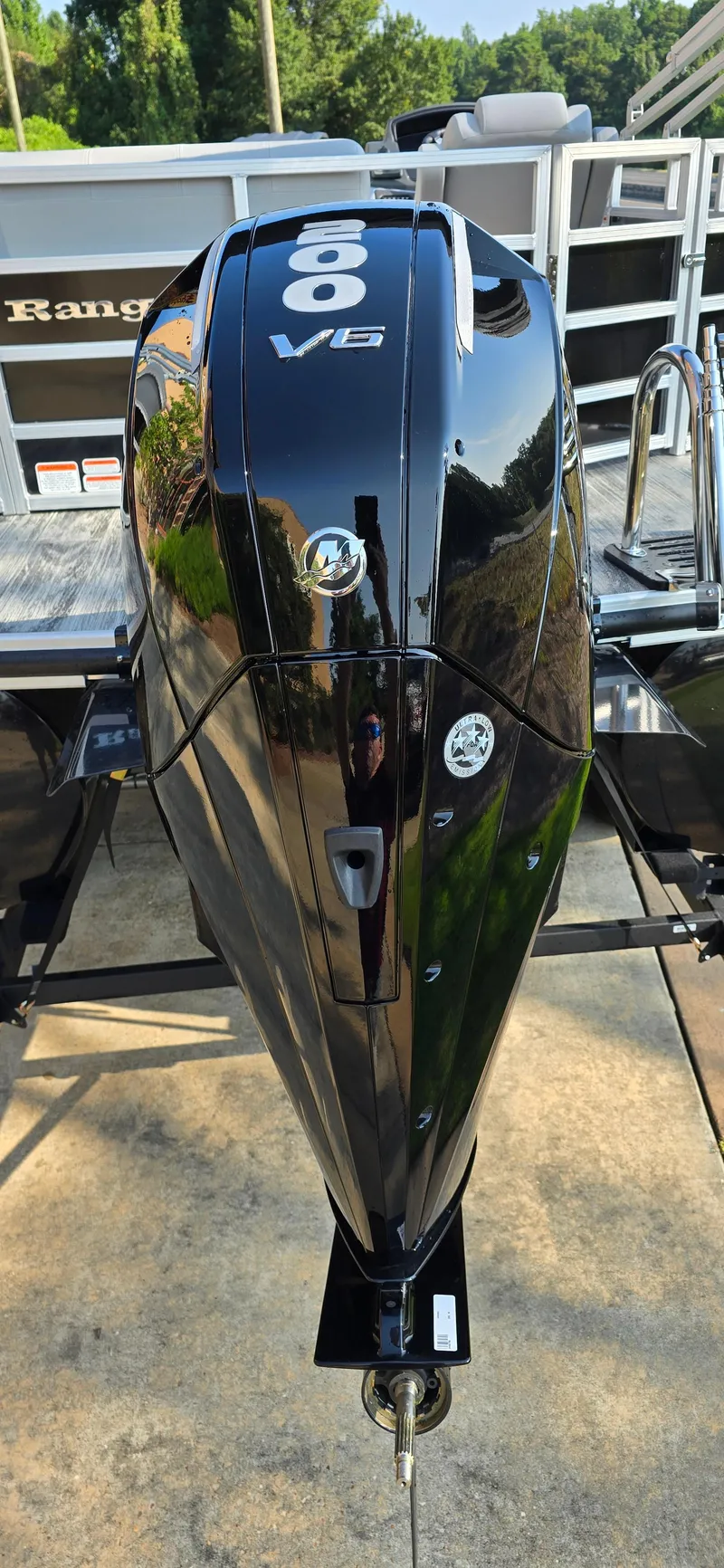 Slide: The Image of 2024 Ranger Reata 223C boat with powerful V6 engine, sleek black design. - 6