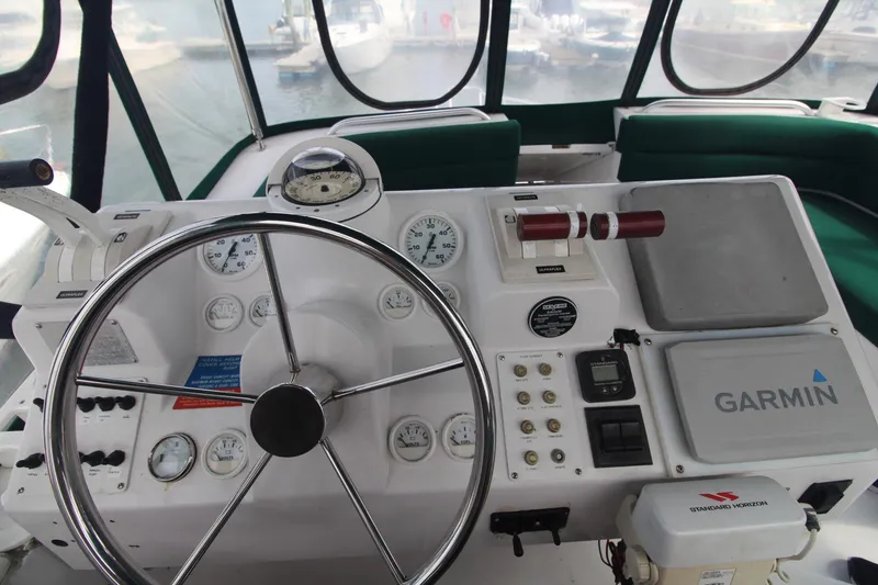 Slide: The Image of 1999 Mainship 31 Sedan Bridge helm with Garmin navigation and control instruments. - 15