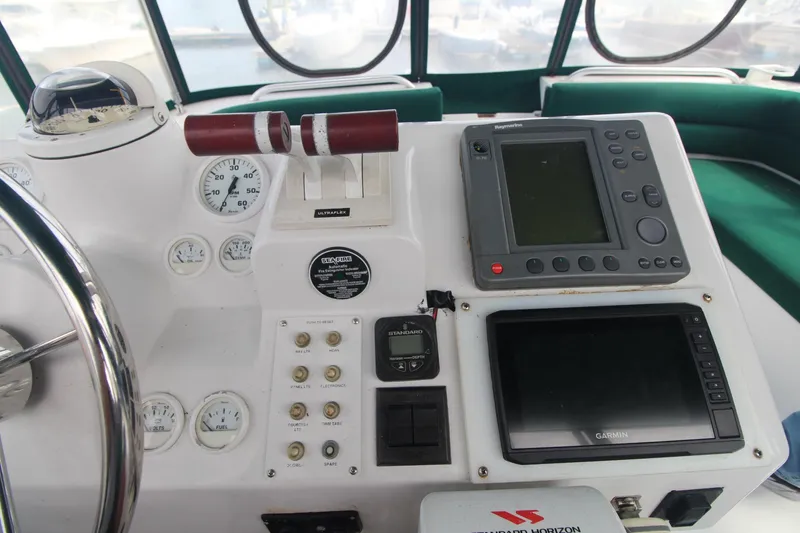 Slide: The Image of Control panel of a 1999 Mainship 31 Sedan Bridge with navigation instruments and gauges. - 16