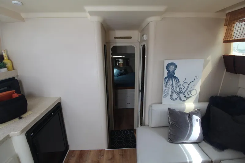 Slide: The Image of Interior of 1999 Mainship 31 Sedan Bridge with modern decor and octopus artwork. - 22