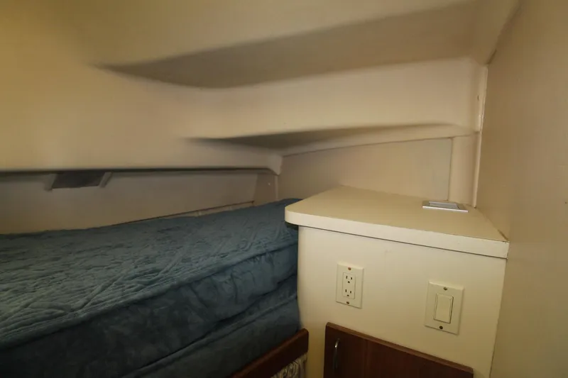 Slide: The Image of 1999 Mainship 31 Sedan Bridge cabin interior with bed and electrical outlets. - 35