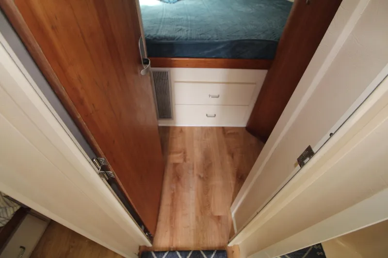 Slide: The Image of 1999 Mainship 31 Sedan Bridge interior with wood flooring and storage drawers. - 39