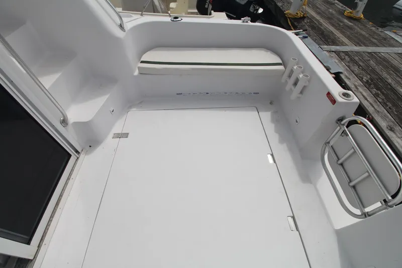 Slide: The Image of 1999 Mainship 31 Sedan Bridge boat deck with white finish and railing. - 41