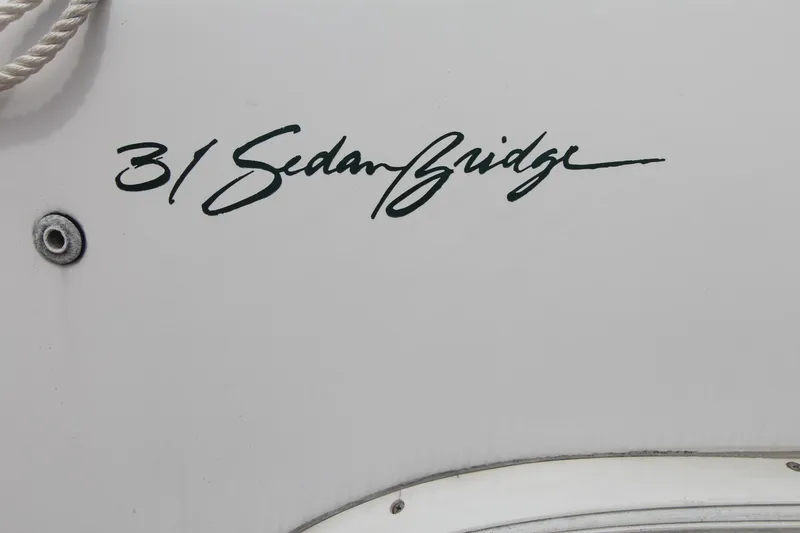 Slide: The Image of 1999 Mainship 31 Sedan Bridge logo on boat exterior. - 6