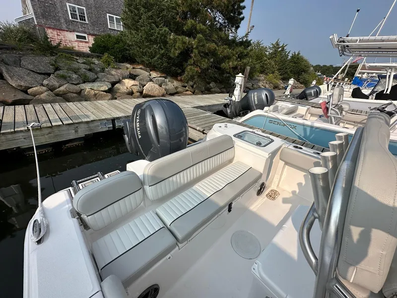Slide: The Image of 2023 Sea Fox 228 Commander boat docked with Yamaha outboard motor. - 2