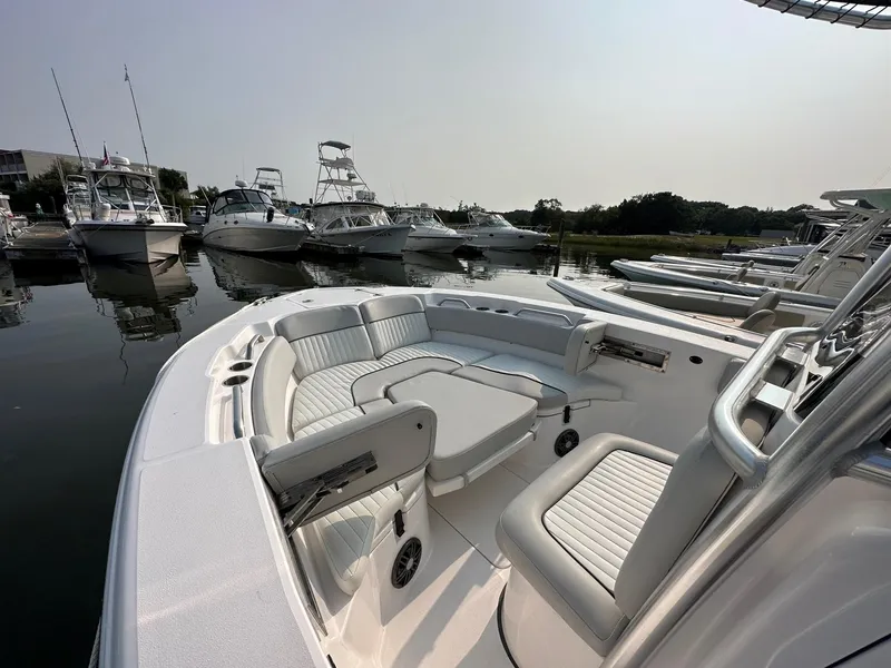 Slide: The Image of 2023 Sea Fox 228 Commander boat interior at marina, featuring comfortable seating. - 5