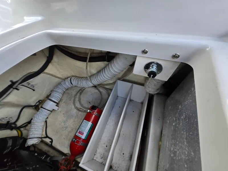 Slide: The Image of 2006 Crownline 255 CCR boat interior with fire extinguisher and ventilation system. - 10
