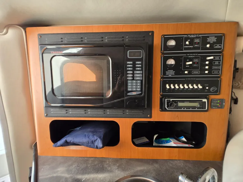 Slide: The Image of 2006 Crownline 255 CCR cabin interior with microwave and control panel. - 17