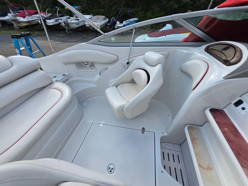 Slide: The Image of 2006 Crownline 255 CCR boat interior with white seating and red accents. - 28