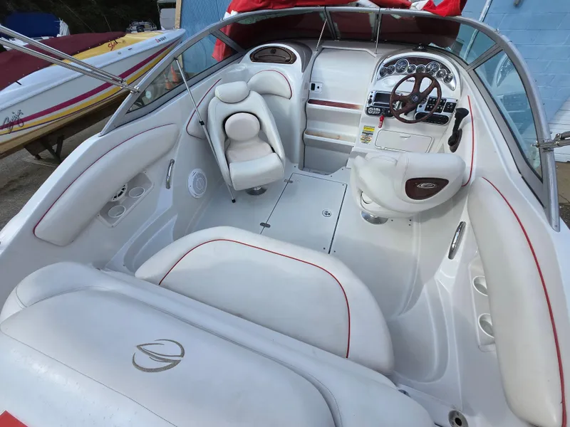 Slide: The Image of 2006 Crownline 255 CCR boat interior with white seating and dashboard. - 30