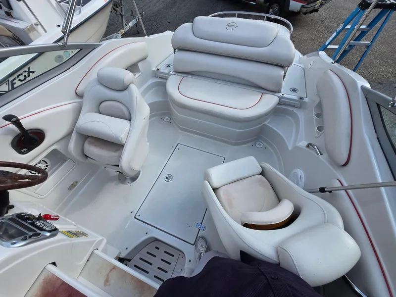 Slide: The Image of 2006 Crownline 255 CCR boat interior with white seating and steering wheel. - 5