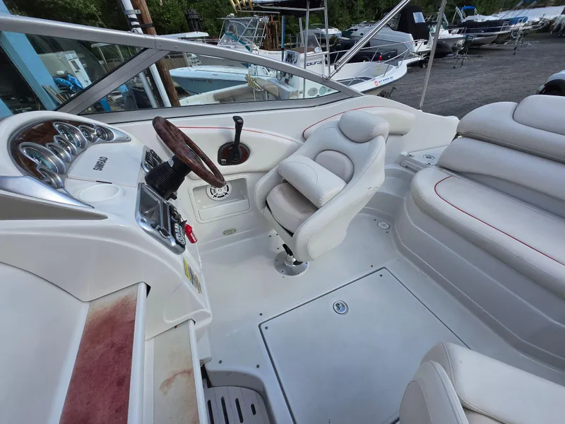 Slide: The Image of 2006 Crownline 255 CCR boat interior with white seating and steering wheel. - 6