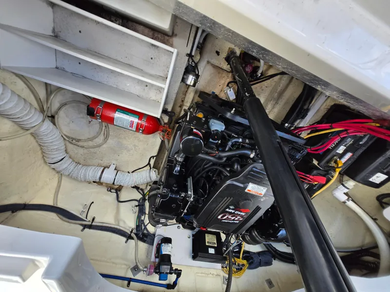 Slide: The Image of Engine compartment of a 2006 Crownline 255 CCR boat, featuring a fire extinguisher and wiring. - 9