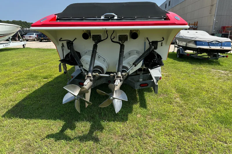 Slide: The Image of 2004 Hustler 388 SLINGSHOT boat with dual propellers on grass. - 10