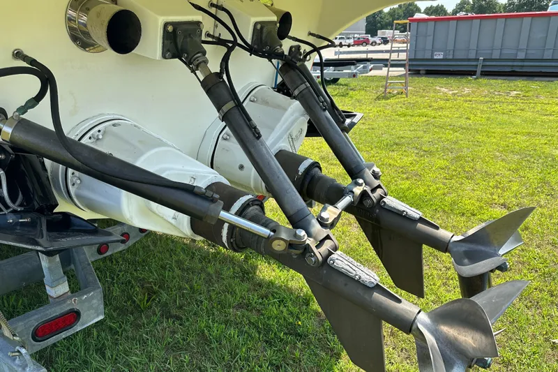 Slide: The Image of Close-up of 2004 Hustler 388 SLINGSHOT boat propellers on grass. - 11