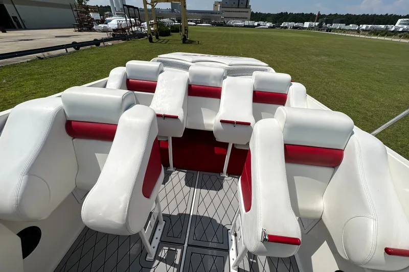 Slide: The Image of 2004 Hustler 388 SLINGSHOT boat interior with white and red seating. - 15