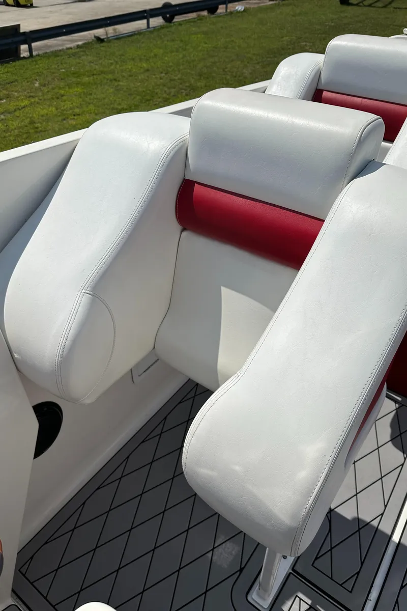 Slide: The Image of 2004 Hustler 388 SLINGSHOT boat interior with white and red seating. - 17