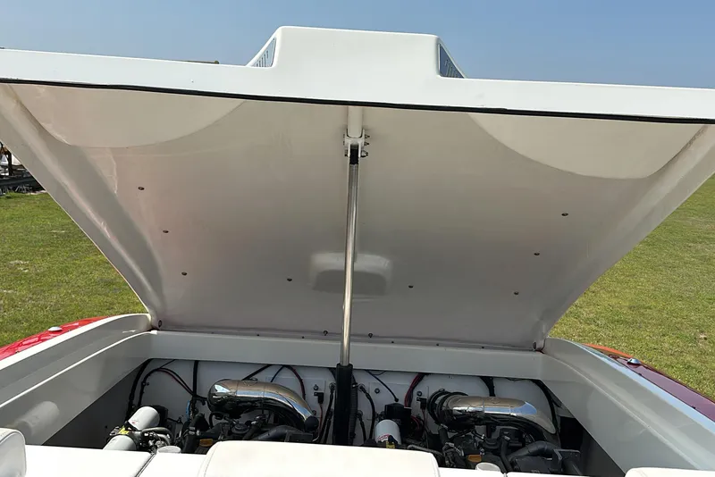 Slide: The Image of 2004 Hustler 388 SLINGSHOT boat engine compartment open, revealing dual engines. - 18