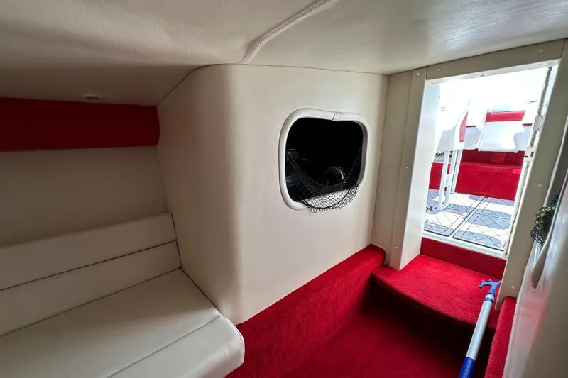 Slide: The Image of 2004 Hustler 388 SLINGSHOT cabin interior with red and white upholstery. - 21